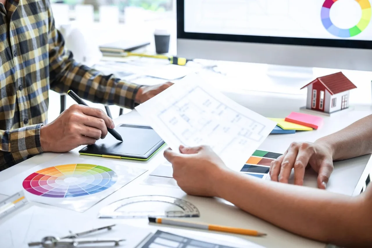 Architect and Designer Collaborating on Floor Plans