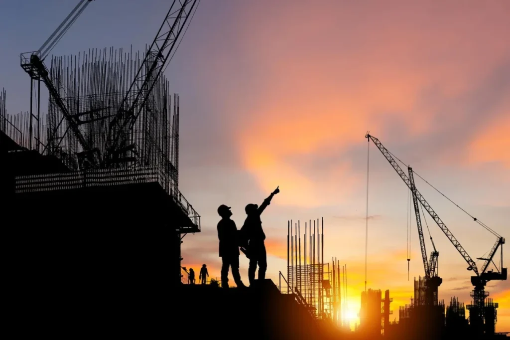 construction site silhouette cranes sunset